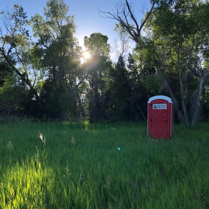 Little Stinkers portable toilet at an outdoor Montana location